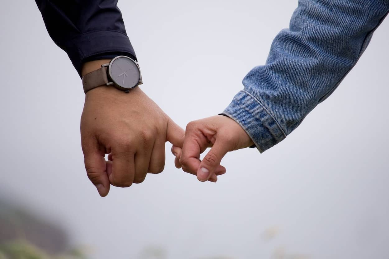 two people holding hands