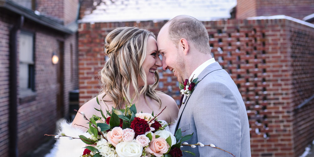 smiling bride and groom looking at each other