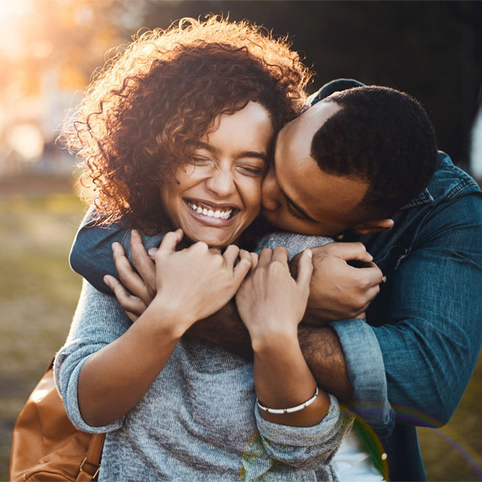 Affectionate young couple bonding together outdoors.